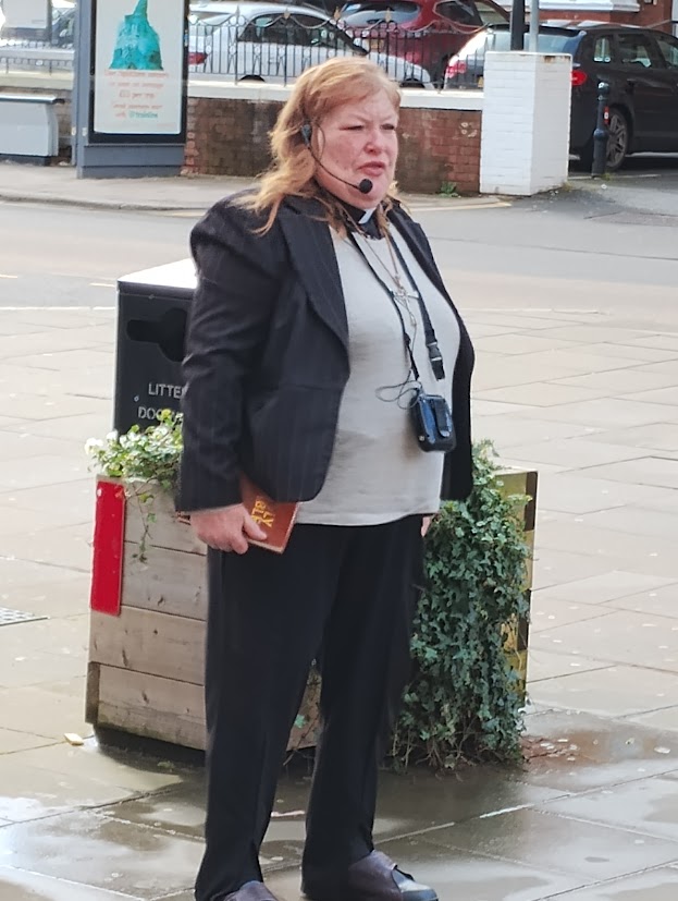 Bishop Elaine of the Cross Denominational Mission street preaching outside Exeter Central