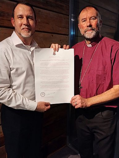 Fr. Chris Sedlmeyer with Bishop Adrian holding the Redemptorist charter Fr. Chris Sedlmeyer with Bishop Adrian holding the Redemptorist charter