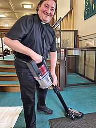 Fr Ruben Mendoza helping tidy up after the principal service Fr Ruben Mendoza helping tidy up after the principal service